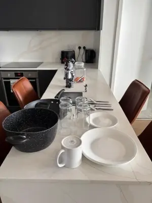 a kitchen with a counter top with plates and bowls at Skyline view 2 bedroom apartment in Moffat