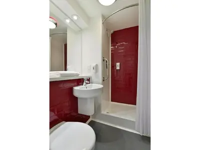 a bathroom with a toilet and a sink and a shower at Travelodge Falkirk in Polmont