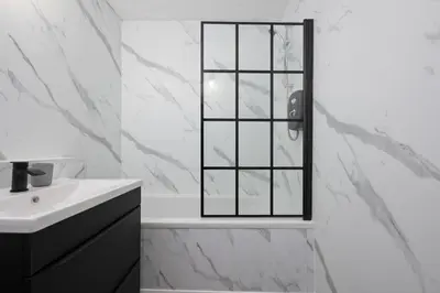 a white bathroom with a sink and a mirror at 2BR Sleeps 6 with Parking Near Linlithgow Palace in Linlithgow
