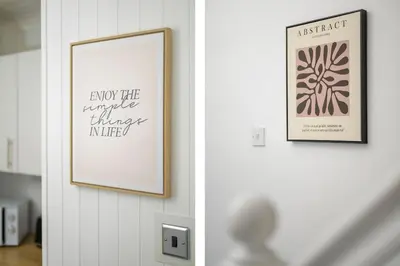 a hallway with two framed pictures on the wall at 2BR Sleeps 6 with Parking Near Linlithgow Palace in Linlithgow