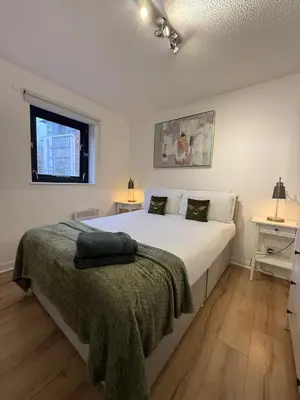 a bedroom with a large white bed and a window at 2BR Sleeps 4 Albion Gate Glasgow City Centre in Glasgow