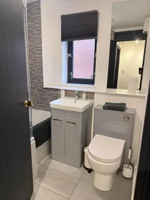 a bathroom with a white toilet and a sink at 2BR Sleeps 4 Albion Gate Glasgow City Centre in Glasgow
