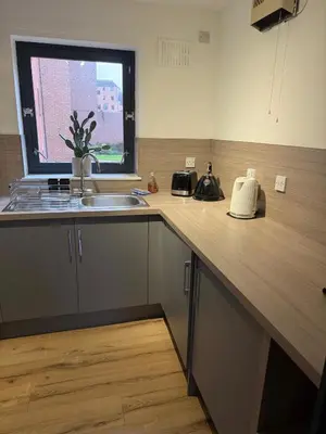 a kitchen with a counter and a sink and a window at 2BR Sleeps 4 Albion Gate Glasgow City Centre in Glasgow