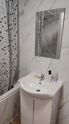 a white bathroom with a sink and a mirror at Cosy Retreat - Suite 5 in Hamilton