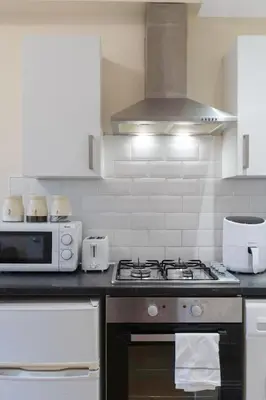 a kitchen with a stove and a microwave at Great location Edinburgh city centre in Edinburgh