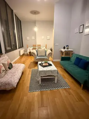 a living room with a couch and a table at Flat in the heart of Liverpool city centre in Moffat