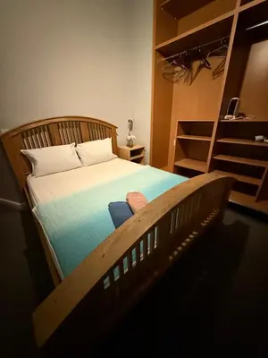 a bedroom with a wooden bed with a ladder at Flat in the heart of Liverpool city centre in Moffat
