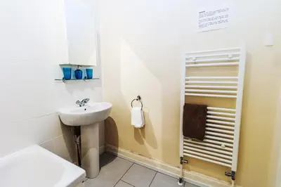 a bathroom with a sink and a shower at Mycosyapartment 47 in Paisley