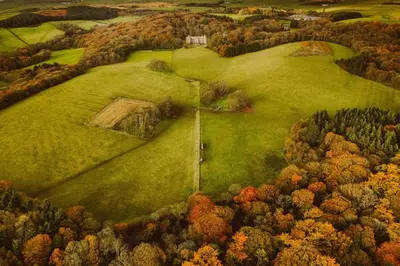 an aerial view of a green field with trees at Castle Penthouse on Estate by the Sea in Enoch