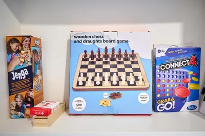 a chess board game and a box on a table at Stylish 1BR Central Oban Retreat in Oban