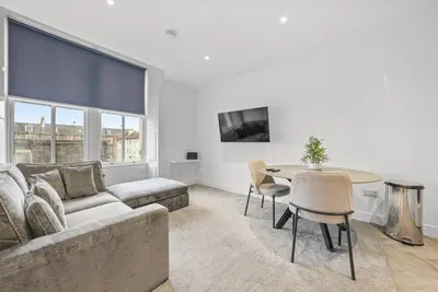 a living room with a couch and a table at The Nook - Beachwalk Apartments in Ayr