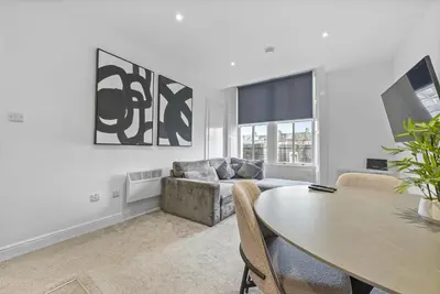 a living room with a table and a couch at The Nook - Beachwalk Apartments in Ayr
