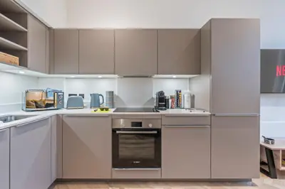 a kitchen with white cabinets and an oven at Central Jewellery Quarter 1-Bedroom with Parking in Moffat