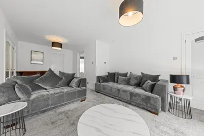 a living room with a couch and a table at The Brora in High Blantyre