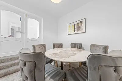a dining room with a table and chairs at The Brora in High Blantyre