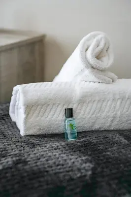 a bottle of soap sitting next to a white towel at Ochil View House in Falkirk