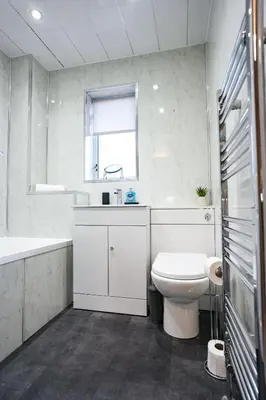 a white bathroom with a sink and a toilet at Ochil View House in Falkirk