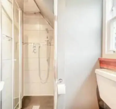 a bathroom with a shower with a glass door at 3 Bed House - Mountain Views Bbq Firepit in Dunoon