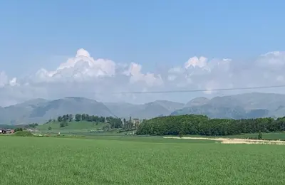 a field of green grass with mountains in the background at Highland Gateway Glamping in Clackmannan