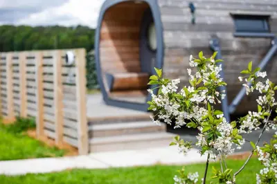 a building with a door and stairs in a yard at Highland Gateway Glamping in Clackmannan