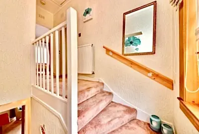 two pictures of a staircase in a house at Cosy 2-Bed Villa in Knightswood