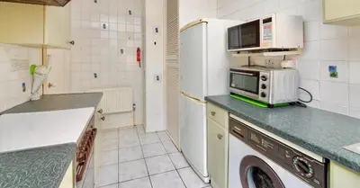 a kitchen with a refrigerator and a microwave at Cosy 2-Bed Villa in Knightswood