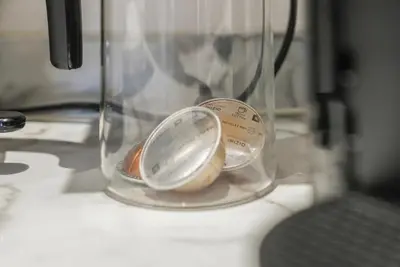 a container with a measuring spoon in a blender at The Snug - Beachwalk Apartments in Ayr