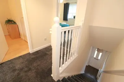 a staircase in a home with a white stair case at Signature Summerhill House in Bearsden