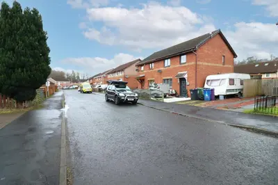 a street with cars parked in front of a house at Signature Summerhill House in Bearsden