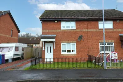 a red brick house with a white door at Signature Summerhill House in Bearsden