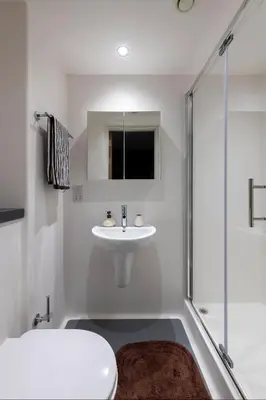 a white bathroom with a sink and a shower at For Students Only - Haymarket Yard in Edinburgh in Edinburgh