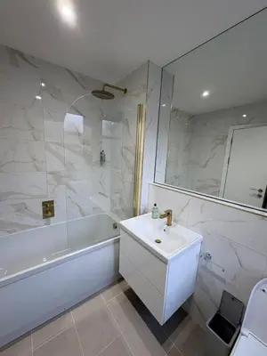 a bathroom with a sink and a bath tub and a sink at Skips in Largs