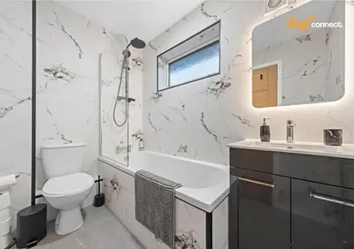a white bathroom with a toilet and a sink at 2 Bed Home in Paisley I Sleeps 4 in Paisley