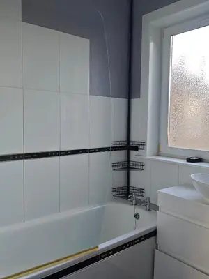 a white bathroom with a tub and a sink at The Boswall Residence in Edinburgh