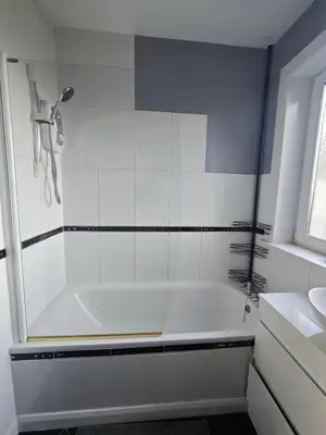 a white bathroom with a tub and a sink at The Boswall Residence in Edinburgh