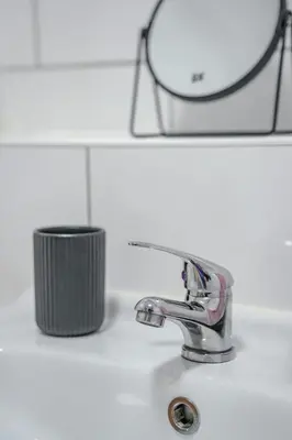 a bathroom sink with a toothbrush and a mirror at Dunward House in Livingston