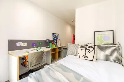 a bedroom with a bed and a desk in it at For Students Only - Dunaskin Mill in Glasgow in Glasgow