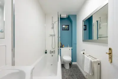 a bathroom with a toilet and a sink at Stylish 2-Bed Flat with Balcony Near Haymarket - Pass the Keys in Edinburgh