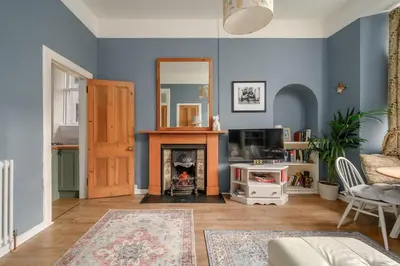 a living room with blue walls and a fireplace at Quiet 1-Bed Flat by the Meadows in Edinburgh