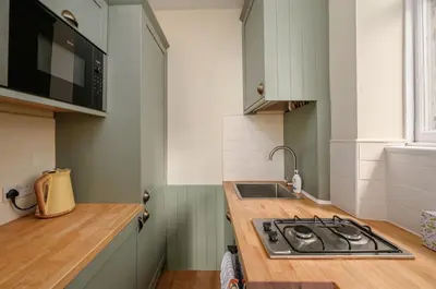 a kitchen with a stove and a counter top at Quiet 1-Bed Flat by the Meadows in Edinburgh