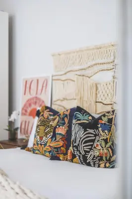 a bed with colorful pillows on top of it at Luxury MArylebone Village family home in Moffat