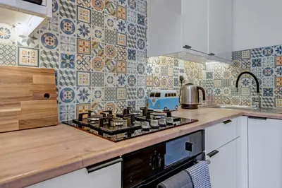 a kitchen with a stove top oven next to a counter at Stylish 2-Bed Villa Garden Central Edinburgh in Edinburgh