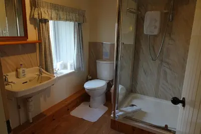 a bathroom with a toilet and a sink and a shower at Finchairn Cottage in Lochgilphead