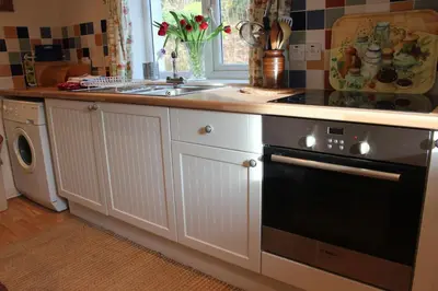 a kitchen with a sink and a stove top oven at South Lodge in Lochgilphead