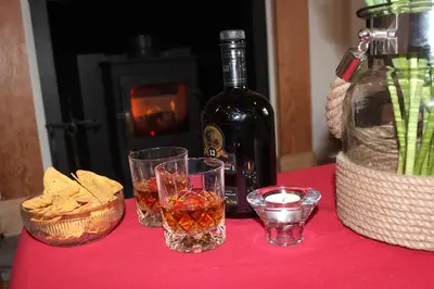 a table with two glasses and a bottle of wine and chips at South Lodge in Lochgilphead