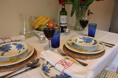 a table with two plates and two glasses of wine at South Lodge in Lochgilphead