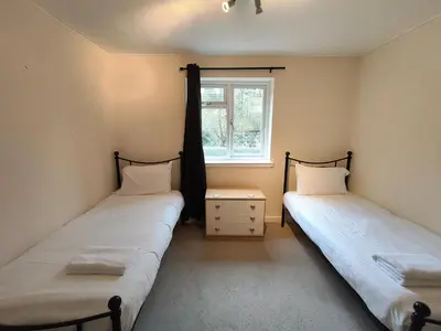 two beds in a room with a window at Fintry Inn in Fintry