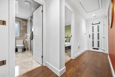 a white hallway with a toilet and a bathroom at 2BR Oban Retreat with Free Parking in Oban