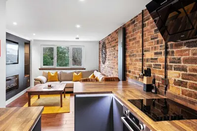 a kitchen and living room with a brick wall at 2BR Oban Retreat with Free Parking in Oban