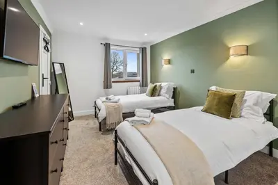 a hospital room with two beds and a television at 2BR Oban Retreat with Free Parking in Oban